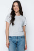 Woman wearing a gray t-shirt and blue jeans against a white background