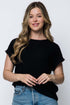 Woman wearing a black t-shirt and blue jeans against a white background
