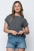Woman wearing a black and white striped shirt and denim shorts on a white background