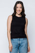 Woman wearing a black sleeveless top and blue jeans on a white background