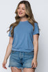 Woman wearing a blue t-shirt and denim shorts on a white background