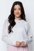 Woman wearing a white sweater with a white background