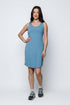 Woman wearing a blue dress standing against a white background