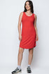 Woman wearing a red dress standing against a white background