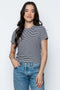 Woman wearing a striped t-shirt and jeans against a white background