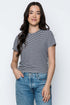 Woman wearing a striped t-shirt and jeans against a white background